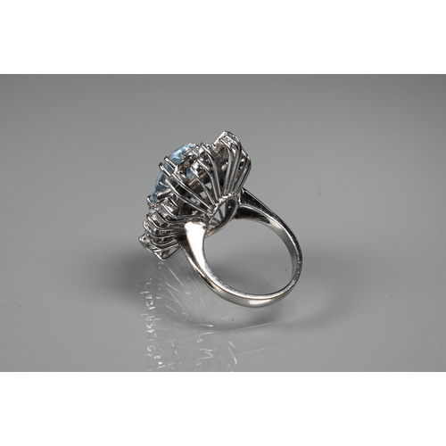 262 - A contemporary statement cluster ring, the oval claw set aquamarine surrounded by an arrangement of ... 