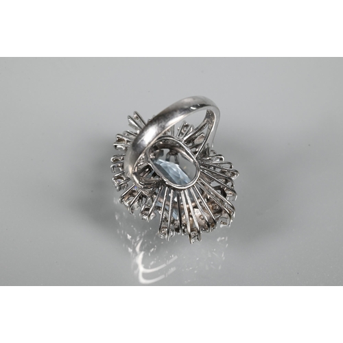 262 - A contemporary statement cluster ring, the oval claw set aquamarine surrounded by an arrangement of ... 