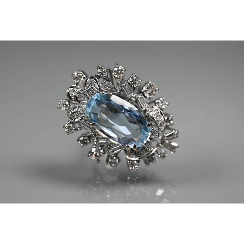 262 - A contemporary statement cluster ring, the oval claw set aquamarine surrounded by an arrangement of ... 