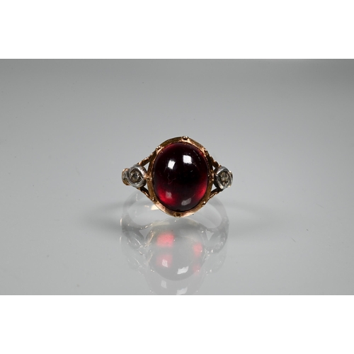 264 - An antique foil backed cabochon red stone with diamond set shoulders in yellow gold fitting, size L