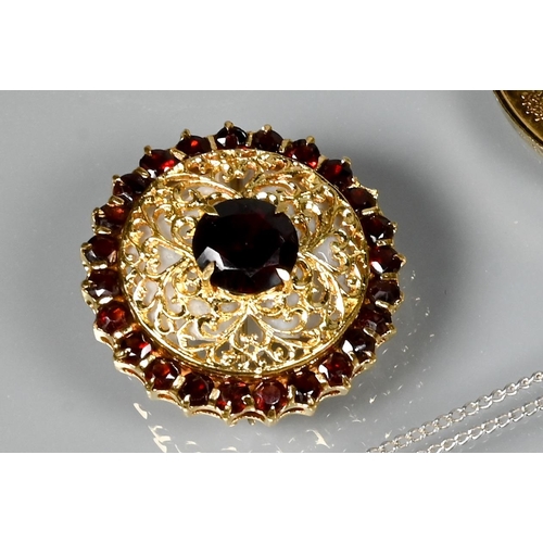 275 - Three various brooches including a circular pierced yellow metal brooch set central garnet with garn... 