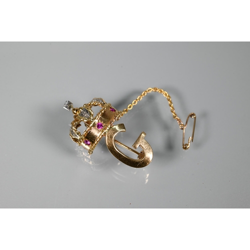 280 - A 1960s yellow metal brooch in form of a crown above the initial 'G', the crown set with rubies and ... 