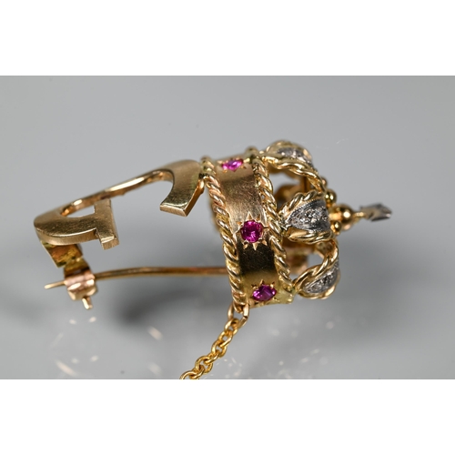 280 - A 1960s yellow metal brooch in form of a crown above the initial 'G', the crown set with rubies and ... 