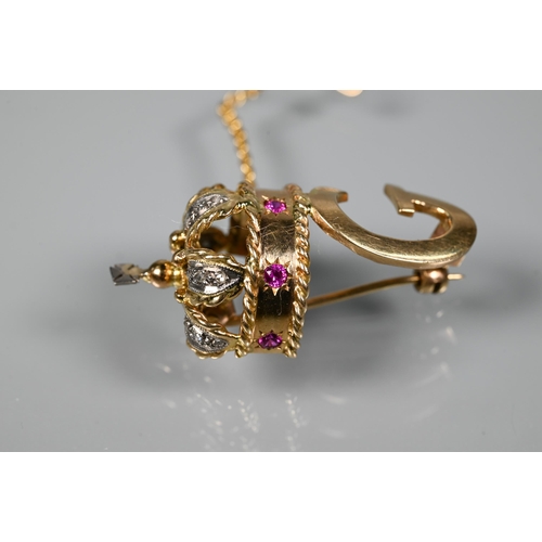 280 - A 1960s yellow metal brooch in form of a crown above the initial 'G', the crown set with rubies and ... 