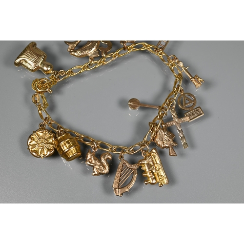 286 - A 9ct curb bracelet with fifteen charms attached including harp, ladder, squirrel, witch on broomsti... 