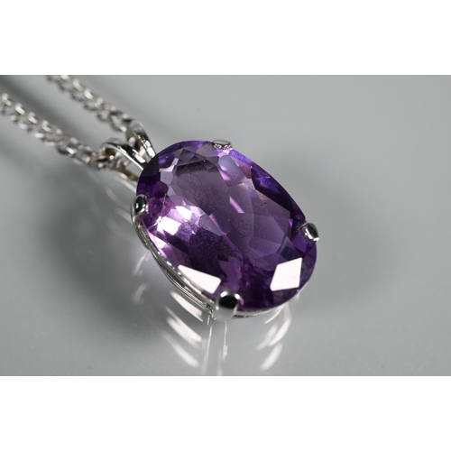 287 - An oval amethyst pendant in claw setting on flat linked white metal chain stamped 750, approx 5.9g (... 