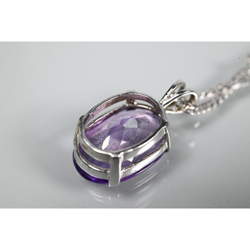 287 - An oval amethyst pendant in claw setting on flat linked white metal chain stamped 750, approx 5.9g (... 