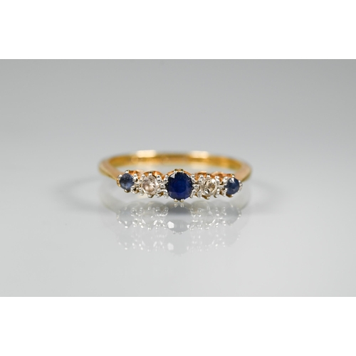 294 - An 18ct yellow gold ring set with five graduated alternate sapphires and diamonds in claw setting, s... 