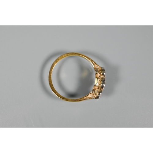 297 - An antique three stone diamond ring, the graduated diamonds in bezel settings, yellow gold set (mark... 