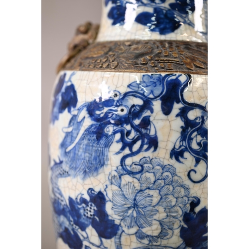 332 - A late 19th century Chinese blue and white 'dragon vase' with brown iron-dust banding and fixed ring... 
