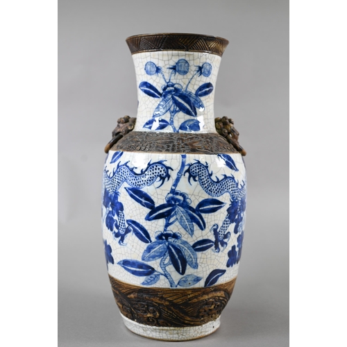 332 - A late 19th century Chinese blue and white 'dragon vase' with brown iron-dust banding and fixed ring... 