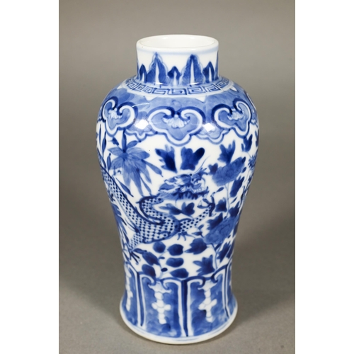 339 - A 19th century Chinese blue and white baluster vase painted with two dragons, Kangxi four-character ... 