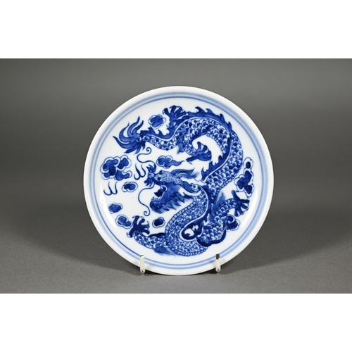 340 - A pair of Chinese blue and white circular stands or dishes, painted in underglaze blue with a dragon... 