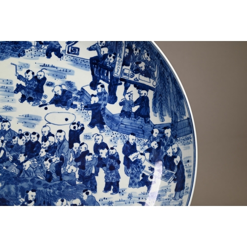 348 - A 20th century Chinese blue and white 'hundred boys' pattern charger, decorated in underglaze blue w... 