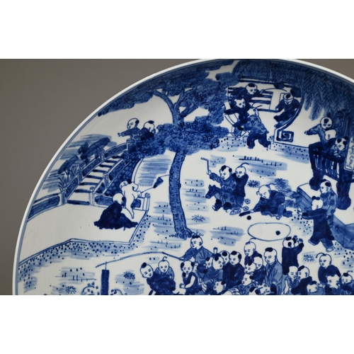 348 - A 20th century Chinese blue and white 'hundred boys' pattern charger, decorated in underglaze blue w... 