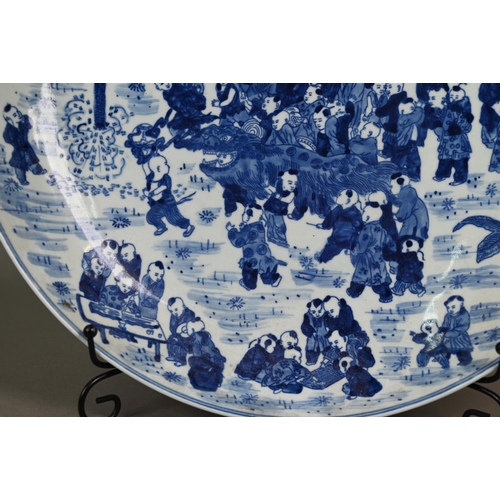 348 - A 20th century Chinese blue and white 'hundred boys' pattern charger, decorated in underglaze blue w... 