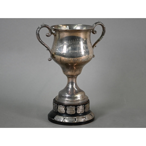 48 - A two-handled silver trophy cup on stemmed foot, London 1922, 9.2oz, 18cm high, on ebonised plinth w... 