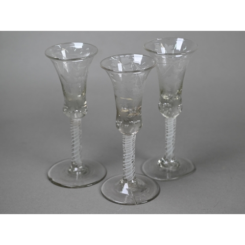 526 - Three 18th Century cordial glasses, the waisted bell bowls wheel-etched with fruiting vine decoratio... 