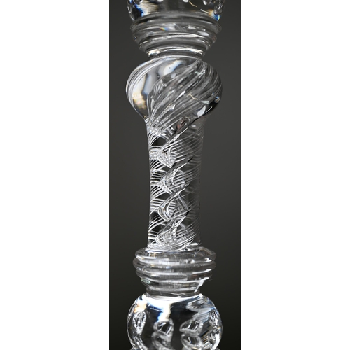 528 - A pair of antique glass candlesticks with plain cylindrical sockets on baluster stems with bubbles a... 