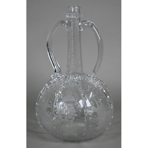 529 - An antique Dutch glass decanter with twin loop handles, applied ribbon-work and etched vine and bird... 