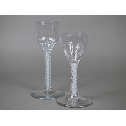 542 - A cordial glass with half-fluted ogee bowl on opaque twist stem, 15 cm, to/w another glass with flor... 