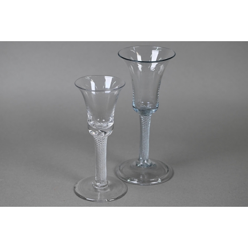 546 - A drinking glass with bell bowl on air twist stem and folded foot, 17 cm to/w a small example on con... 