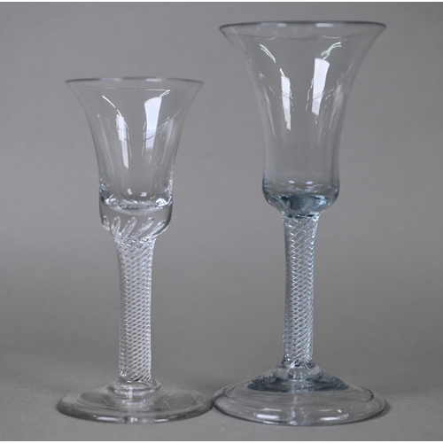 546 - A drinking glass with bell bowl on air twist stem and folded foot, 17 cm to/w a small example on con... 