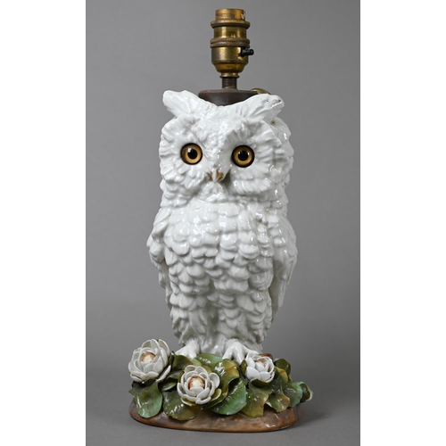 561 - A Victorian china lamp base, modelled as an owl standing on floral-encrusted base, with glass eyes, ... 