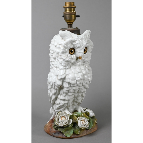 561 - A Victorian china lamp base, modelled as an owl standing on floral-encrusted base, with glass eyes, ... 