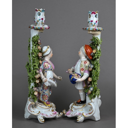 562 - A pair of Samson of Paris gold anchor candlesticks, modelled with flower-sellers on Rococo bases, 27... 