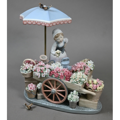 571 - A boxed Lladro figure, 'Flowers of the Season'/'Puesto de Flores', 1454, 26.5 x 23 cm.No losses; one... 