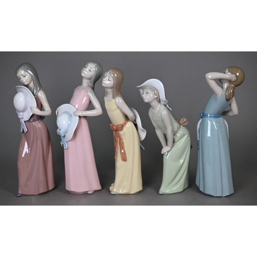 576 - Five unboxed Lladro figures of girls with hats, 13-15 cm, to/w a pair of Gres figures 'Tall' and 'Sh... 