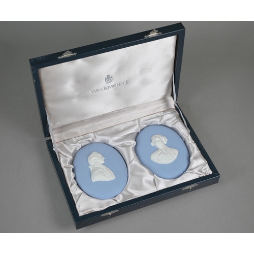 578 - A pair of Wedgwood pale blue Jasper portrait plaques of 18th century gentlemen, 13 x 10 cm, produced... 