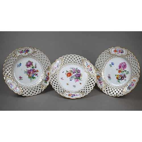 582 - Three Meissen cabinet plates, painted with floral sprays and insects within basket-weave pierced rim... 