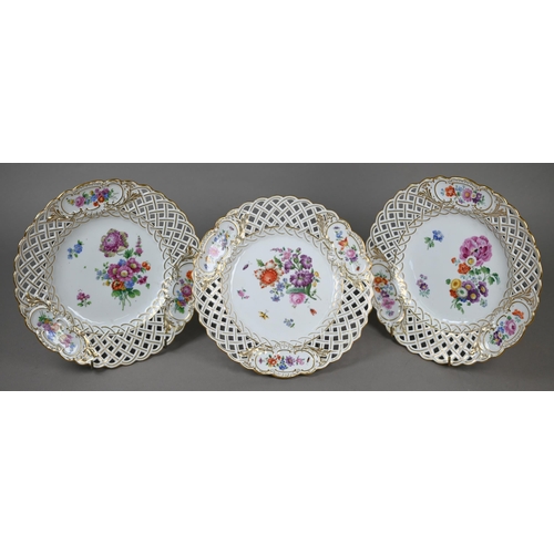 582 - Three Meissen cabinet plates, painted with floral sprays and insects within basket-weave pierced rim... 