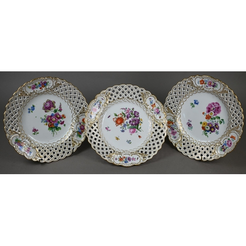 582 - Three Meissen cabinet plates, painted with floral sprays and insects within basket-weave pierced rim... 