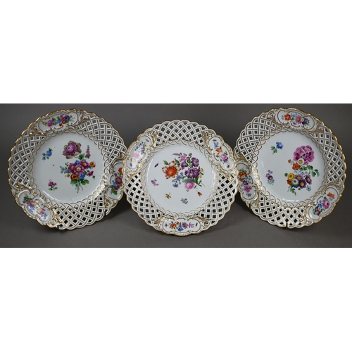 582 - Three Meissen cabinet plates, painted with floral sprays and insects within basket-weave pierced rim... 