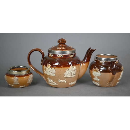 598 - Three Royal Doulton stoneware harvest jugs with silver rims, to/w a three-piece bachelor tea set and... 