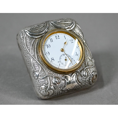 66 - An Edwardian travel clock with Art Nouveau embossed and chased silver front to the strut-case, Dougl... 