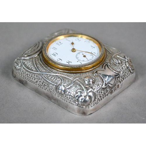 66 - An Edwardian travel clock with Art Nouveau embossed and chased silver front to the strut-case, Dougl... 