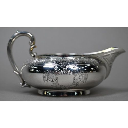 71 - A Victorian silver milk jug of compressed form with engraved decoration and scroll handle, Garrards,... 