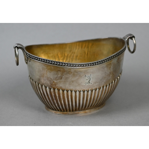 75 - A Victorian silver half-reeded sugar basin of elliptical form with ring handles, Frederick Brasted, ... 