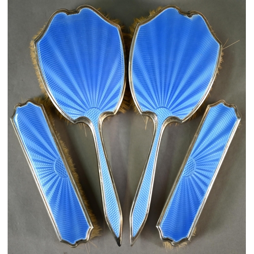 81 - An Art Deco blue guilloche enamel and silver five-piece brush set, Harrods, London 1940Mirror and on... 