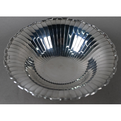 87 - An Art Deco silver dish with radiating shallow flutes and moulded rim, on raised foot, Selfridge &am... 