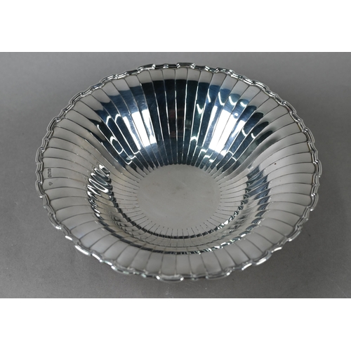 87 - An Art Deco silver dish with radiating shallow flutes and moulded rim, on raised foot, Selfridge &am... 