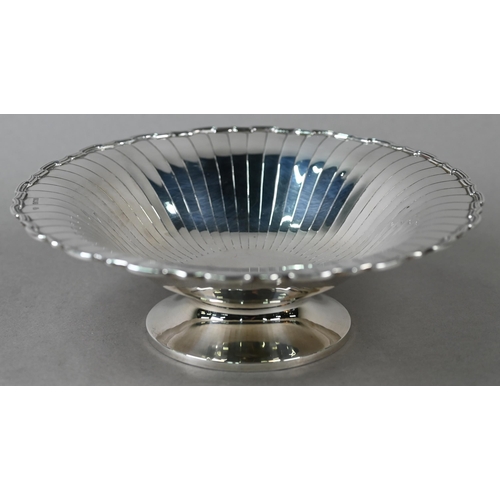 87 - An Art Deco silver dish with radiating shallow flutes and moulded rim, on raised foot, Selfridge &am... 