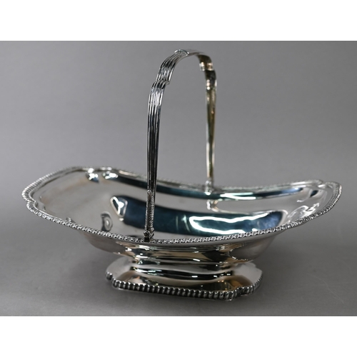 88 - A George III silver fruit basket with reeded swing handle, gadrooned rims and raised foot, engraved ... 