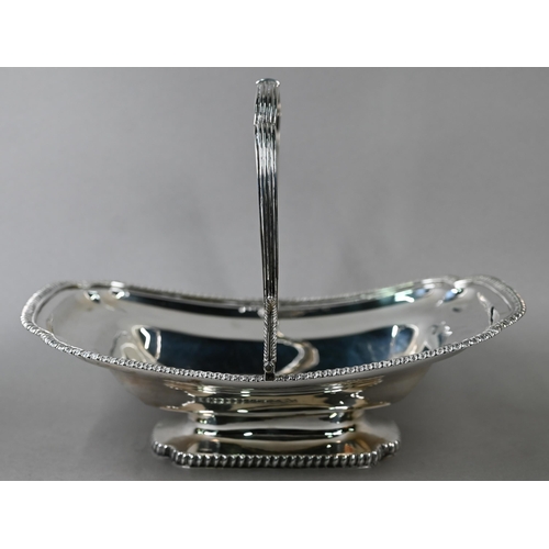 88 - A George III silver fruit basket with reeded swing handle, gadrooned rims and raised foot, engraved ... 