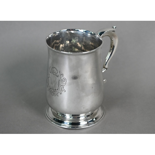 90 - A George III silver baluster pint mug with scroll handle and moulded flared foot, maker -F (rubbed),... 