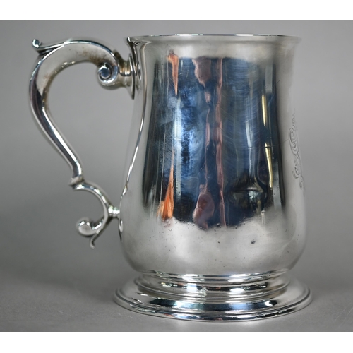 90 - A George III silver baluster pint mug with scroll handle and moulded flared foot, maker -F (rubbed),... 